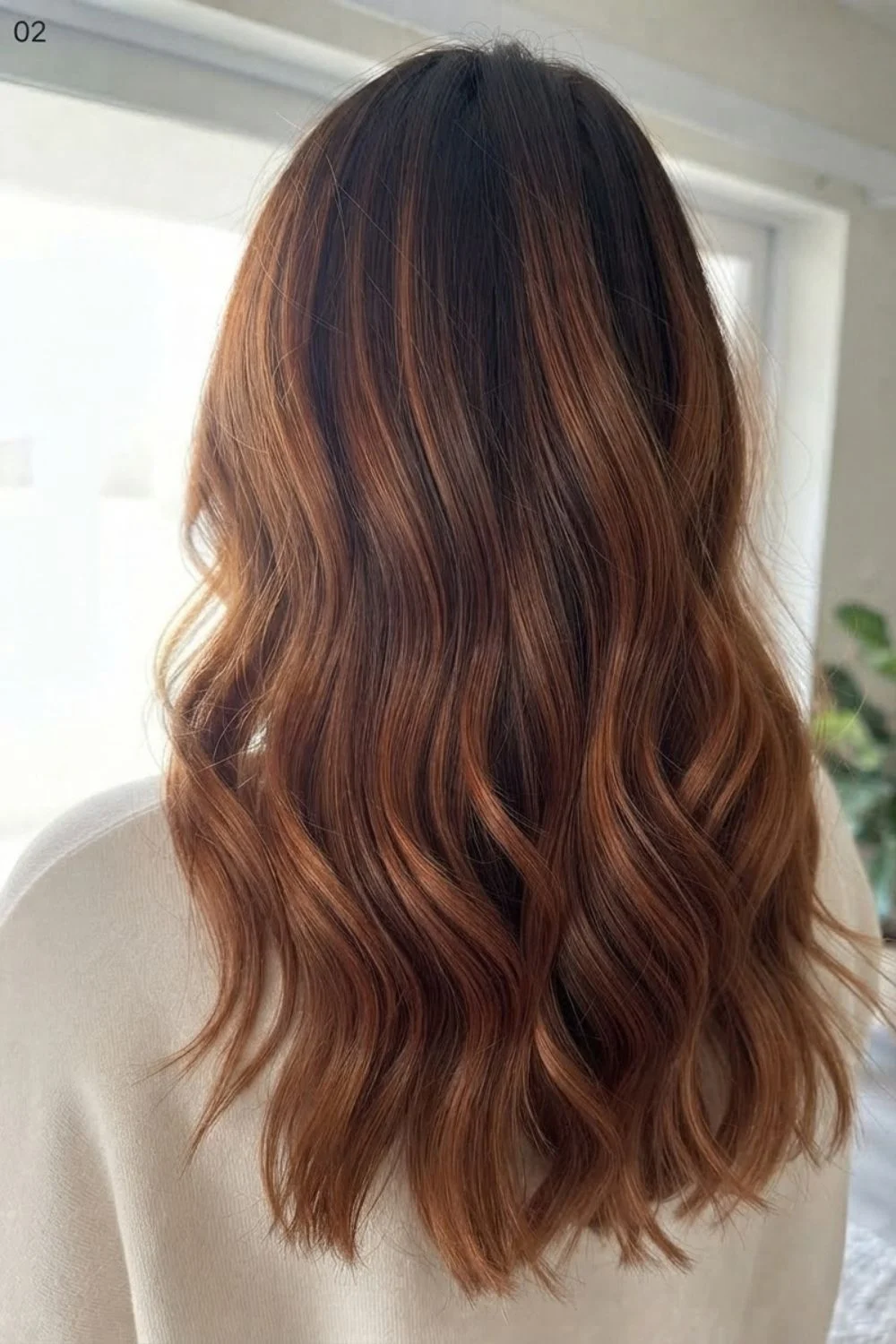Brunette hair with copper balayage through the mid-lengths and ends
