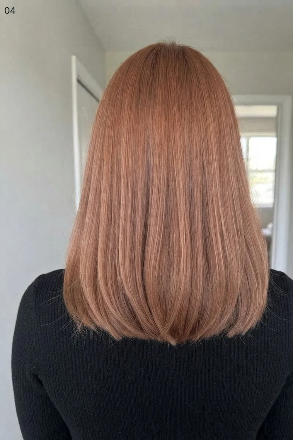 Muted soft copper lob with a natural shoulder-length finish