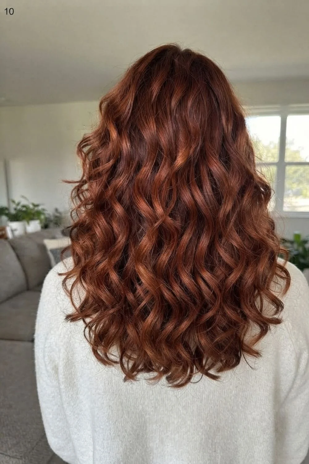 Deep auburn-copper curls with rich brown-red depth