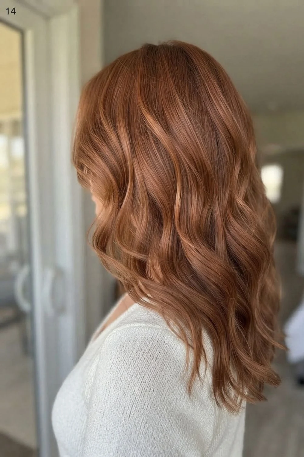 Soft copper hair with natural movement viewed from a side-back angle